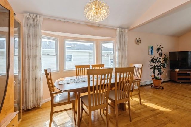 dining area with vaulted ceiling, light wood-type flooring, a baseboard radiator, and an inviting chandelier