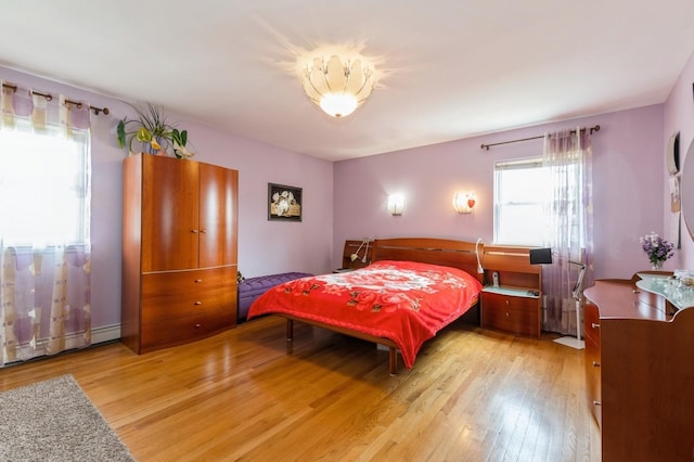 bedroom featuring a baseboard radiator and light wood-style flooring