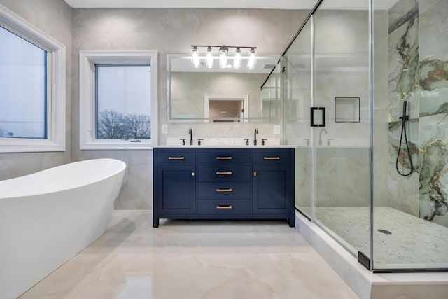 full bathroom featuring double vanity, a soaking tub, a marble finish shower, and a sink