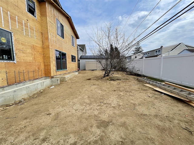 20 Baker Ln, Levittown, NY 11756 - view of yard featuring an outbuilding and fence