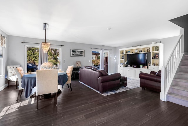 living room with stairs and wood finished floors