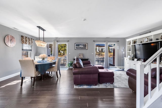 living area with baseboards and dark wood finished floors