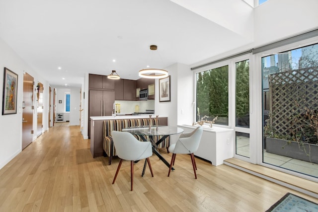 dining area with recessed lighting and light wood finished floors