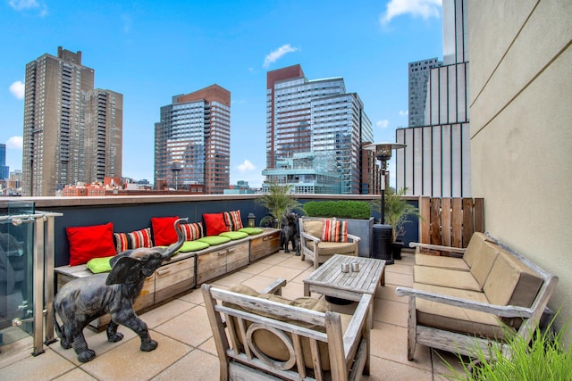 view of patio / terrace featuring an outdoor hangout area and a city view