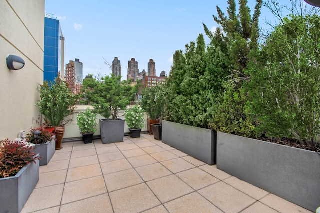 view of patio with a city view and a balcony