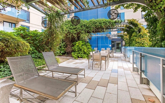 view of patio with outdoor dining area and a pergola