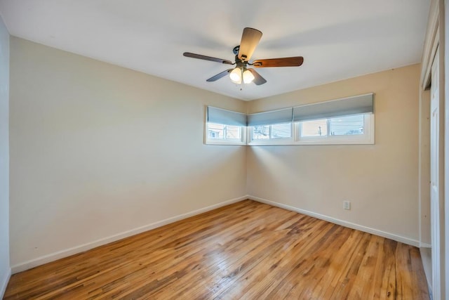 unfurnished bedroom featuring light wood-style flooring, a ceiling fan, and baseboards