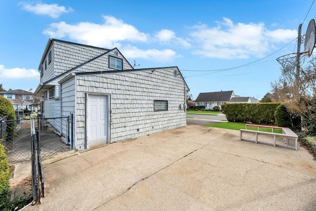 garage featuring a gate and fence