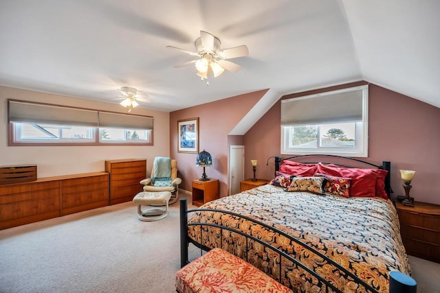 bedroom with a ceiling fan, lofted ceiling, and carpet floors