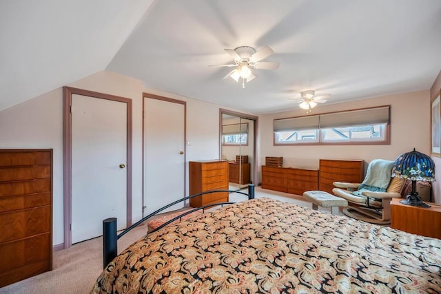 bedroom with a closet, lofted ceiling, light colored carpet, and a ceiling fan