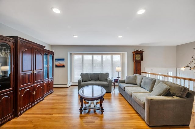 living area with recessed lighting, light wood-style floors, and a baseboard radiator