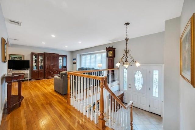 entrance foyer featuring an inviting chandelier, recessed lighting, visible vents, and light wood finished floors