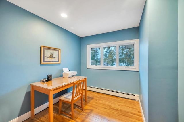 office space with recessed lighting, a baseboard radiator, baseboards, and wood finished floors