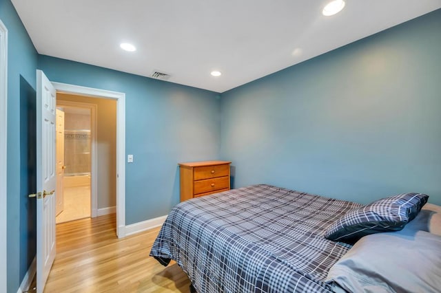 bedroom with visible vents, recessed lighting, light wood-type flooring, and baseboards