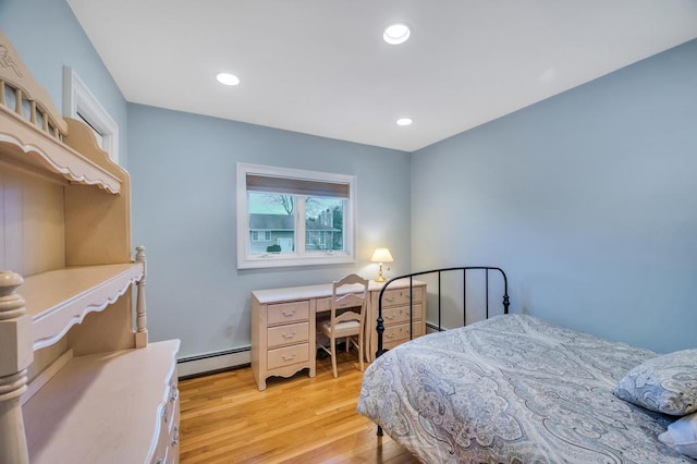 bedroom featuring light wood finished floors, recessed lighting, and a baseboard radiator