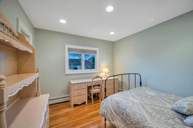 bedroom featuring a baseboard heating unit, recessed lighting, light wood-style floors, and baseboard heating