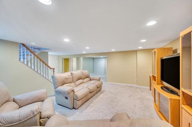 living room with recessed lighting, stairway, baseboards, and light colored carpet