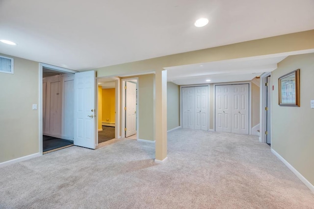 finished below grade area featuring carpet flooring, recessed lighting, visible vents, and baseboards