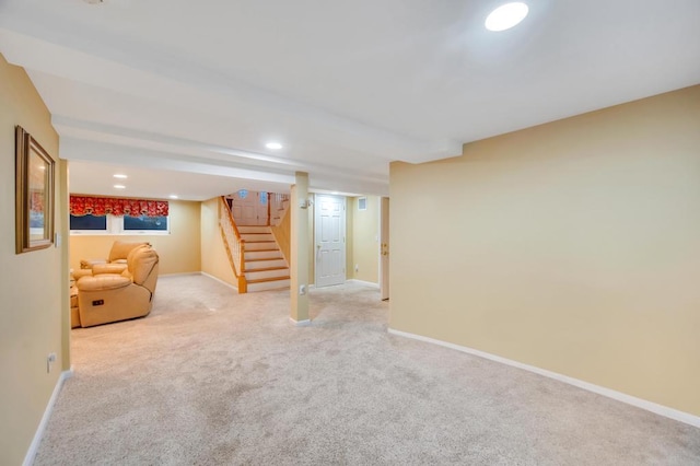 finished basement featuring recessed lighting, baseboards, light carpet, and stairs