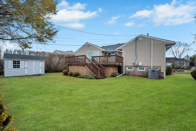 view of yard with stairway, a wooden deck, central AC unit, an outdoor structure, and a storage unit