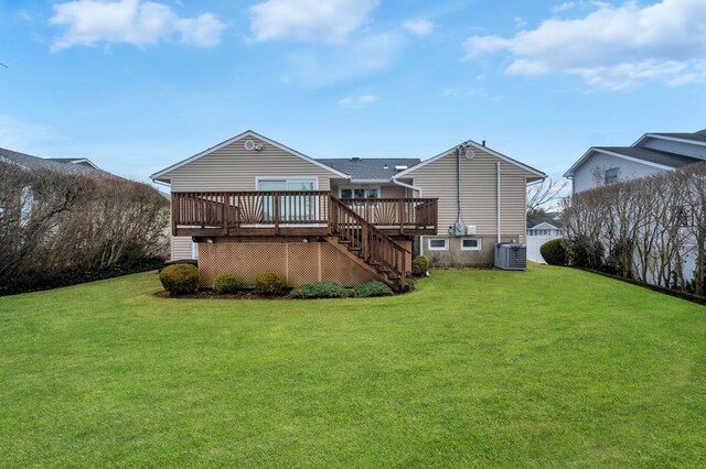 back of house featuring a lawn, central AC, a deck, and stairs