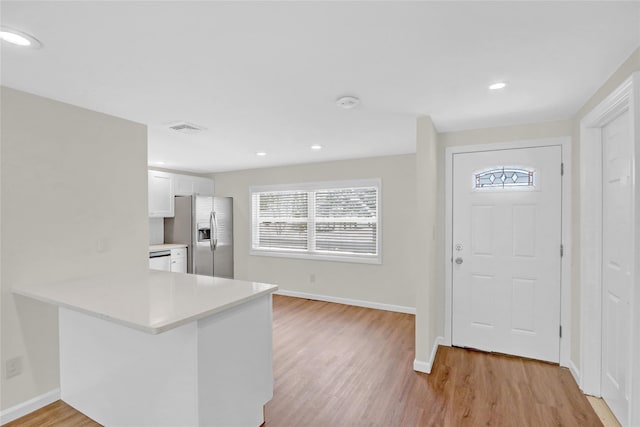 foyer entrance with recessed lighting, visible vents, baseboards, and light wood-style flooring