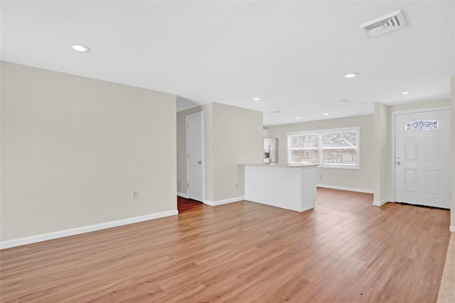 unfurnished living room featuring recessed lighting, visible vents, baseboards, and light wood finished floors