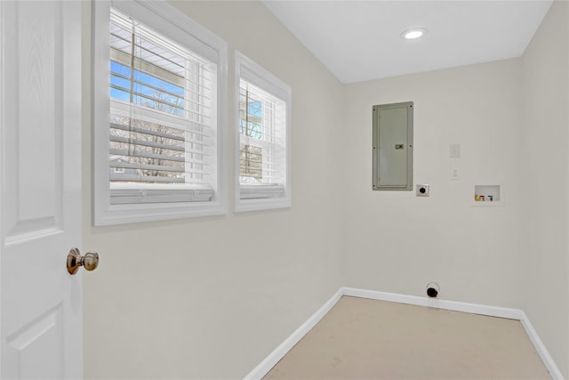 clothes washing area featuring electric dryer hookup, washer hookup, electric panel, baseboards, and laundry area