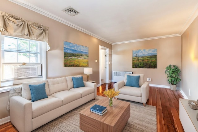 living area featuring visible vents, light wood-type flooring, crown molding, and baseboards