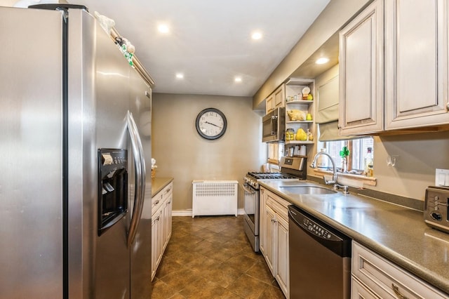 kitchen featuring a sink, radiator, recessed lighting, appliances with stainless steel finishes, and open shelves