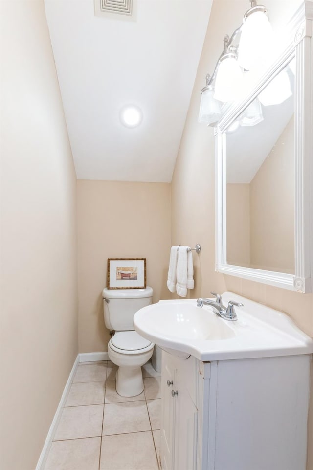 half bath featuring tile patterned flooring, visible vents, baseboards, toilet, and vanity