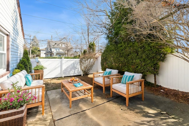 view of patio with an outdoor living space and a fenced backyard