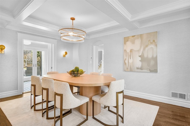 dining room featuring light wood-type flooring, visible vents, beam ceiling, and baseboards