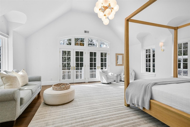 bedroom featuring access to exterior, visible vents, a chandelier, french doors, and wood finished floors