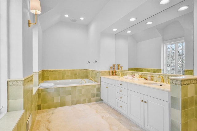 bathroom with double vanity, lofted ceiling, and a sink