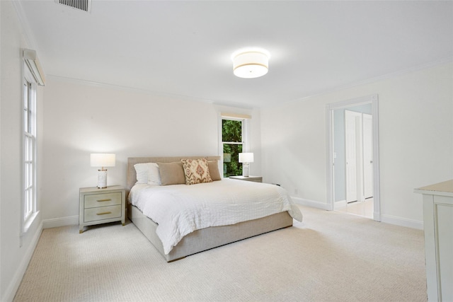 bedroom with light carpet, visible vents, baseboards, and ornamental molding