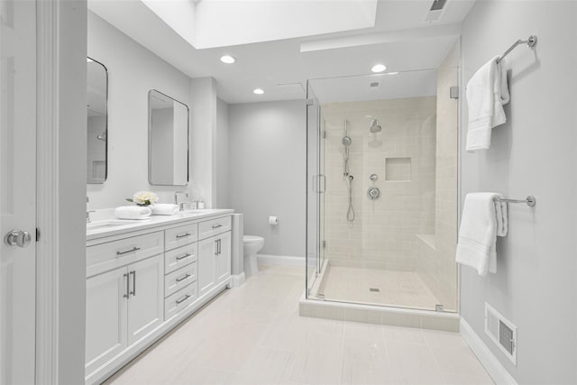 bathroom with double vanity, visible vents, toilet, and a stall shower