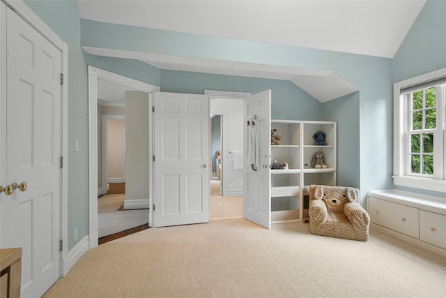 unfurnished room with vaulted ceiling, carpet, and baseboards