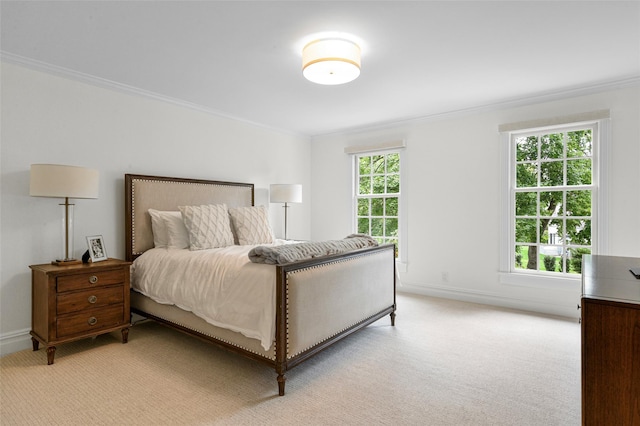 bedroom featuring light colored carpet, baseboards, and ornamental molding