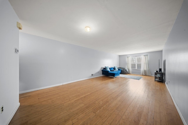 interior space featuring wood-type flooring and baseboards