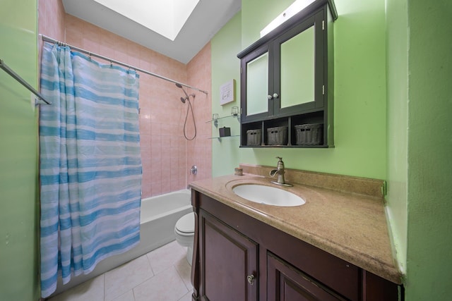 full bath with toilet, shower / tub combo, a skylight, vanity, and tile patterned floors