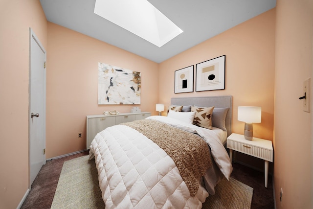 carpeted bedroom with a skylight and baseboards