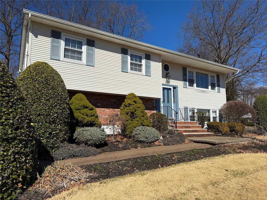 raised ranch featuring brick siding