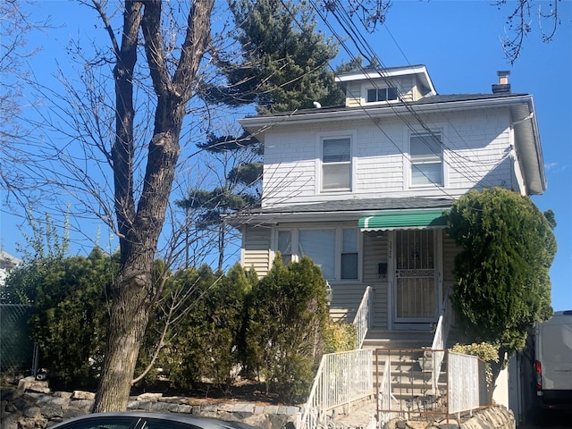 view of front facade with a chimney