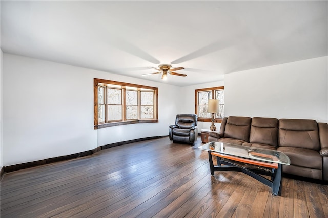 living room featuring a ceiling fan, baseboards, and hardwood / wood-style flooring