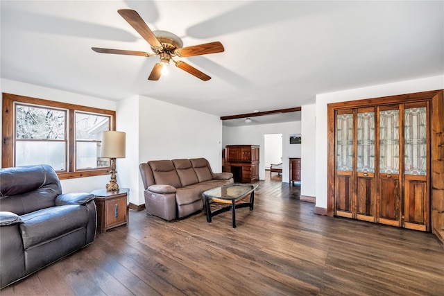 living area featuring ceiling fan, dark wood finished floors, and baseboards