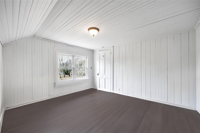 additional living space featuring lofted ceiling and dark wood finished floors