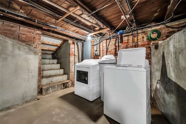 unfinished basement featuring stairs and separate washer and dryer