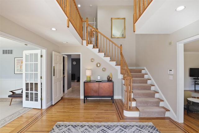 stairs featuring visible vents, recessed lighting, baseboards, and wood finished floors