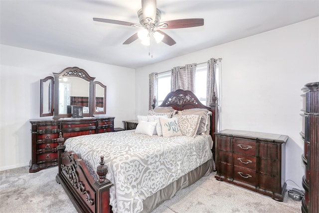 bedroom with ceiling fan, baseboards, and light carpet